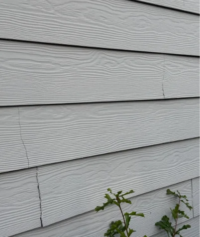 Visible horizontal crack in exterior weatherboard-style cladding.