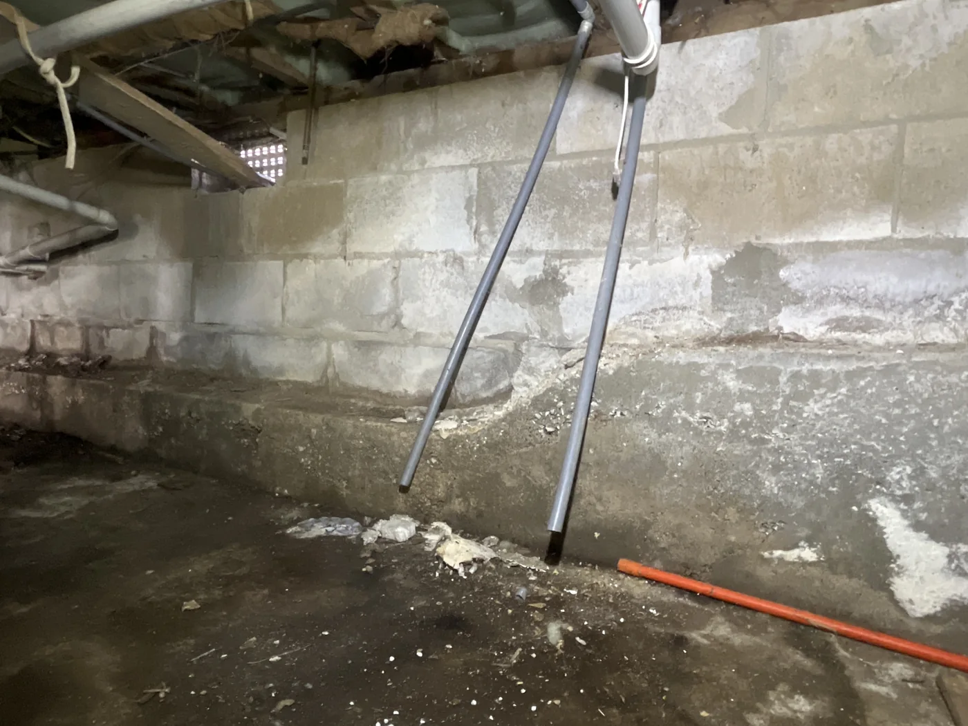 Subfloor blockwork and ground area showing visible damp subfloor conditions.